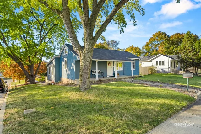 a view of house with outdoor space and garden
