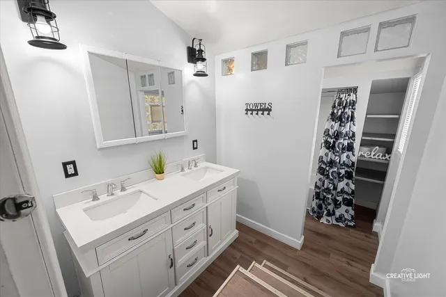 a bathroom with a double vanity sink and mirror