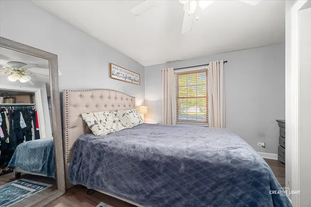 a bedroom with a large bed and a window