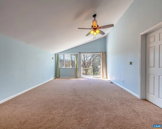 a bed room with a bed couches and a flat tv screen