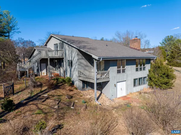 a view of a house with wooden fence