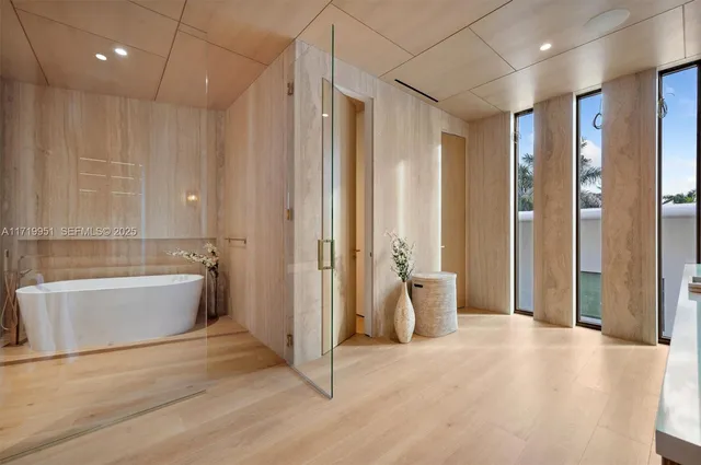 a bedroom with a bed and large window