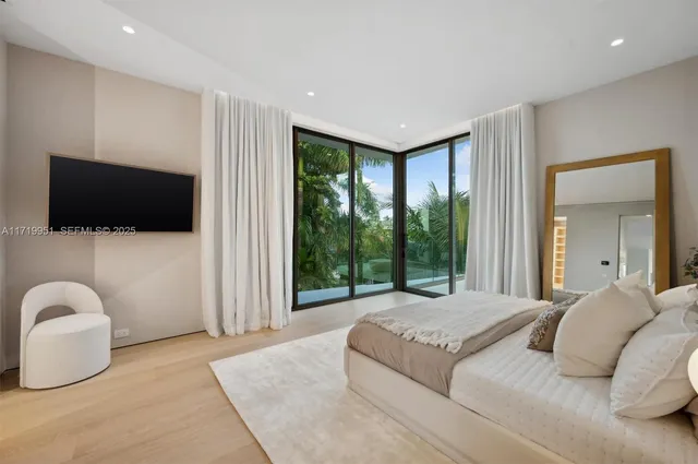 a bedroom with a bed and a mirror