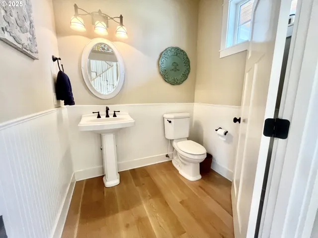 a bathroom with a toilet and a mirror