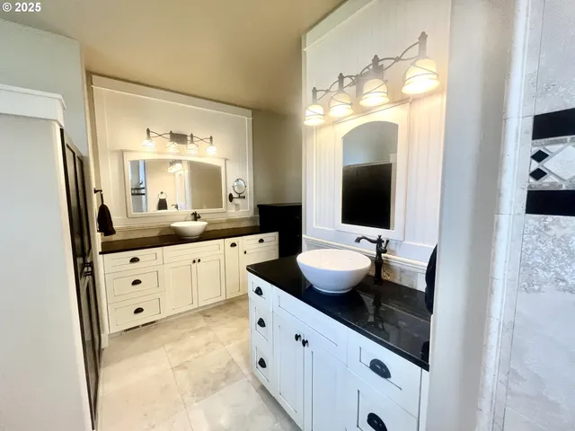 a bathroom with a double vanity sink and mirror
