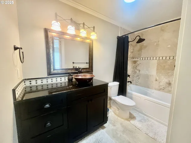 a bathroom with a sink vanity mirror and toilet