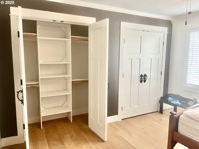 a view of room with walk in closet and bedroom view
