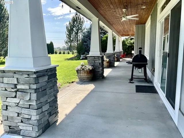 a living room with patio furniture and garden view