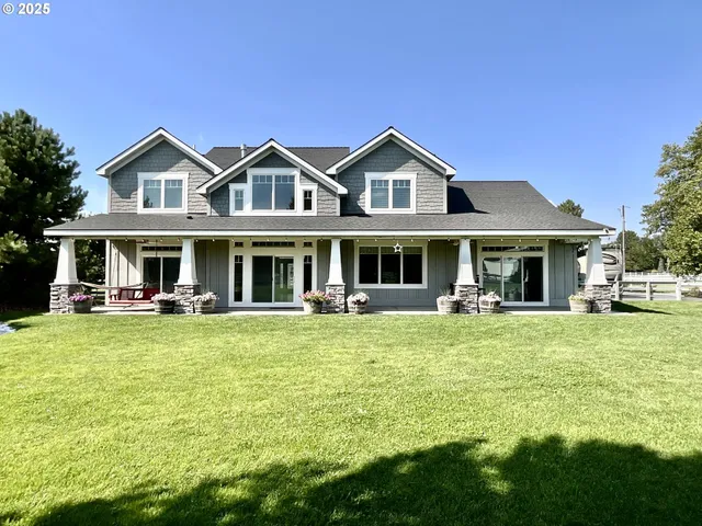 a front view of house with outdoor seating yard and green space