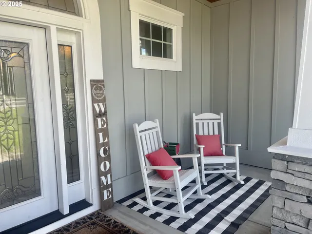 a living room with furniture a rug and a window