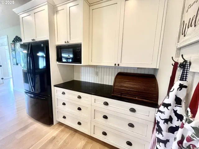 a kitchen with granite countertop a sink a stove and a refrigerator