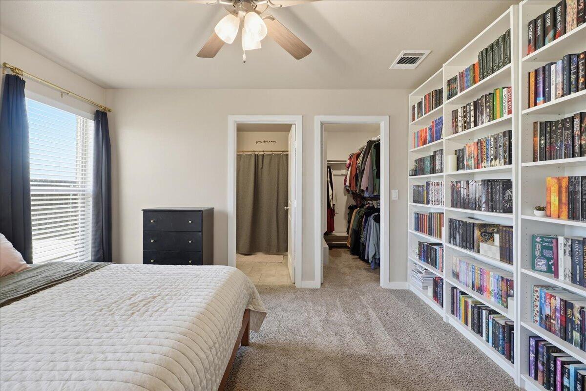 7440 32nd Street Lubbock, TX 79407 - Photo 15 of 29 a bed room with a bed and a book shelf