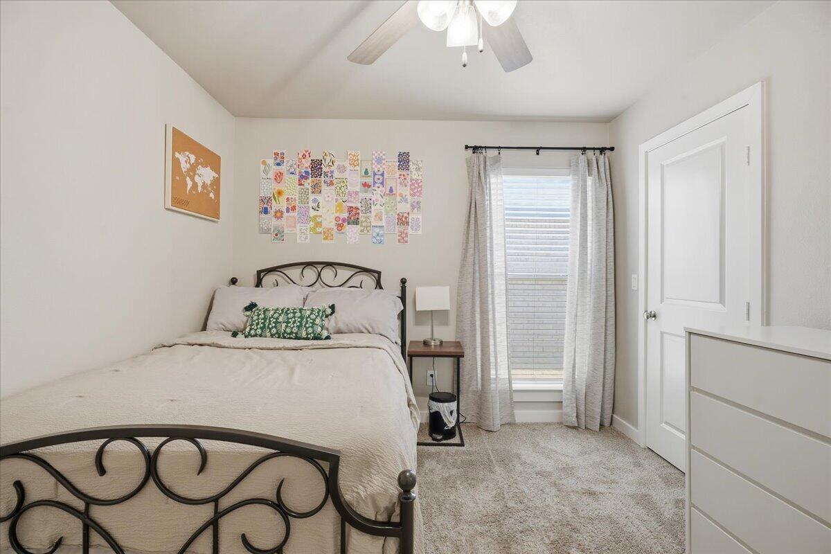 7440 32nd Street Lubbock, TX 79407 - Photo 22 of 29 a bedroom with a bed and a painting on the wall
