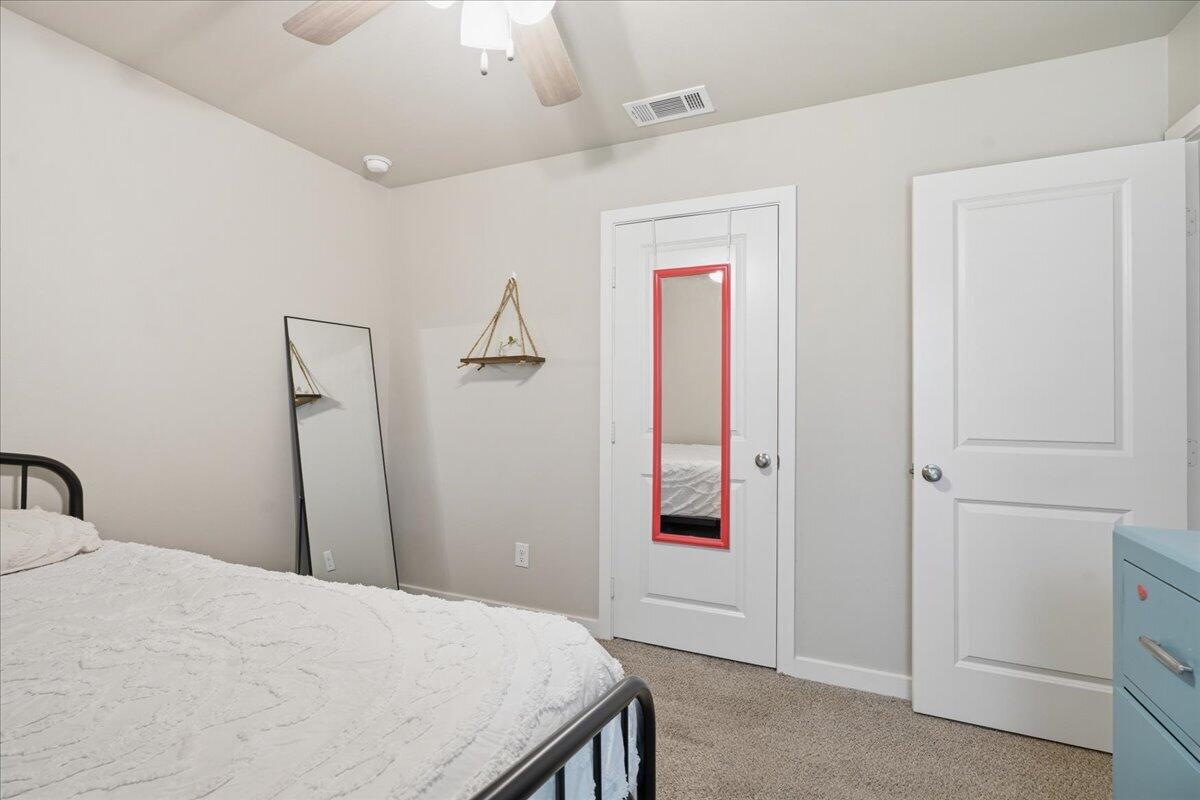 7440 32nd Street Lubbock, TX 79407 - Photo 24 of 29 a bedroom with a bed and a mirror