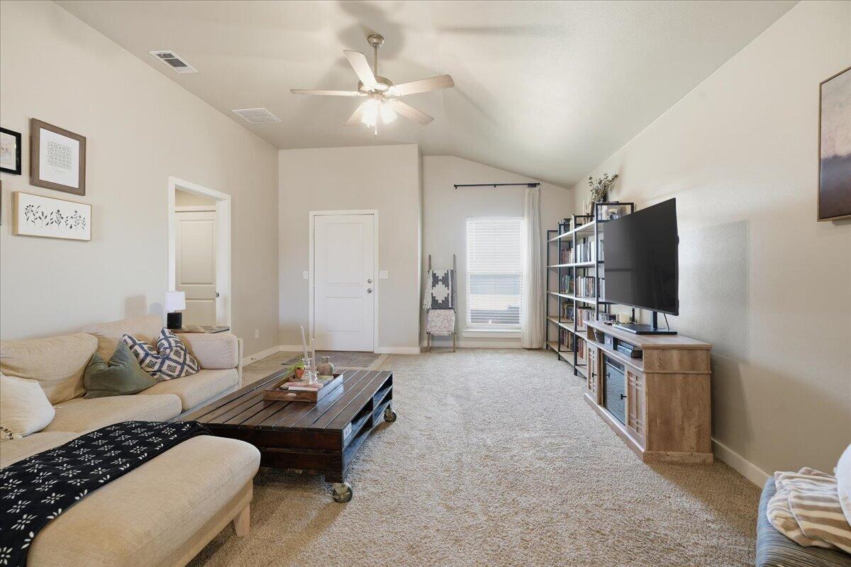 7440 32nd Street Lubbock, TX 79407 - Photo 5 of 29 a living room with furniture and a flat screen tv