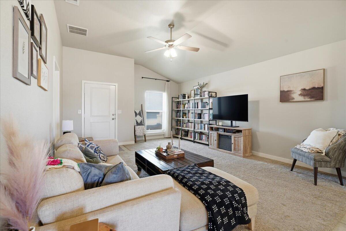 7440 32nd Street Lubbock, TX 79407 - Photo 6 of 29 a bedroom with a bed and a flat screen tv