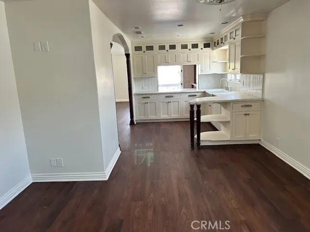 a kitchen with a sink window and cabinets