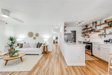 a living room with furniture and a wooden floor