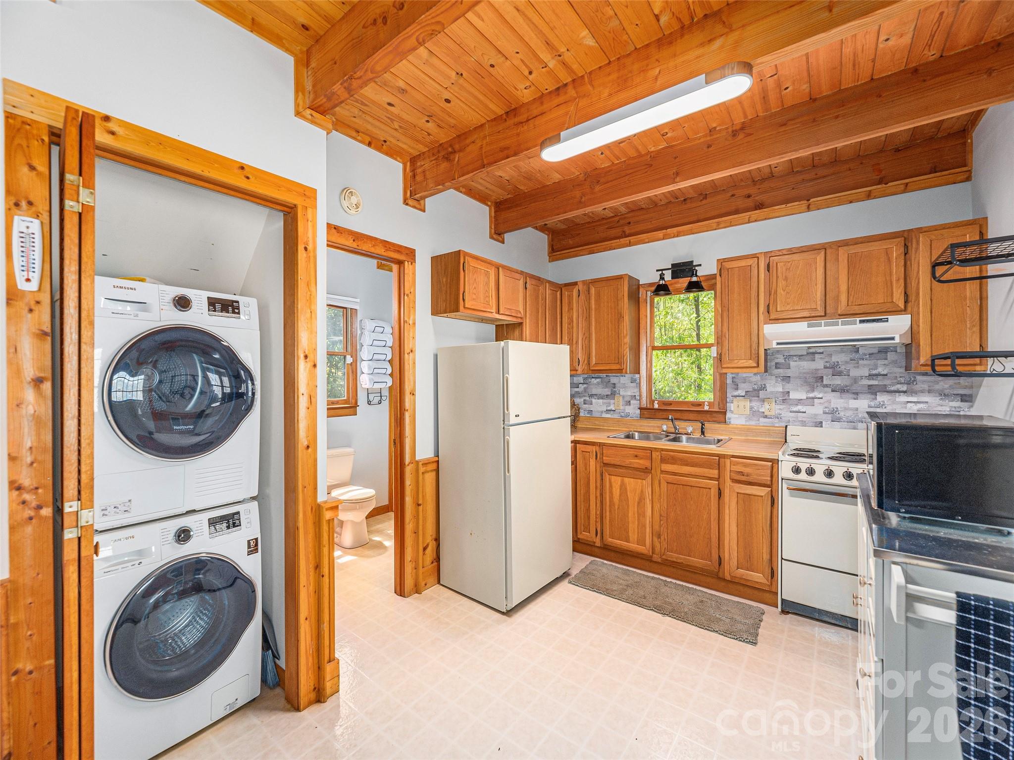 240 Plott Balsam Road Maggie Valley, NC 28751 - Photo 11 of 24 a kitchen with a refrigerator and a stove