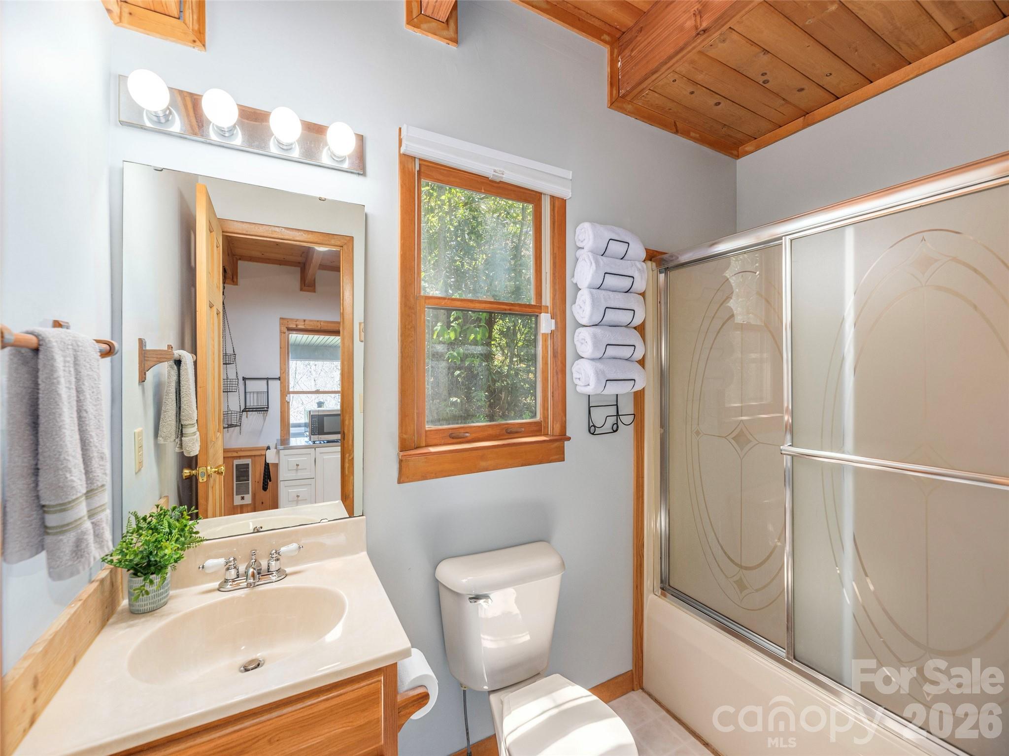 240 Plott Balsam Road Maggie Valley, NC 28751 - Photo 12 of 24 a bathroom with a sink toilet and shower