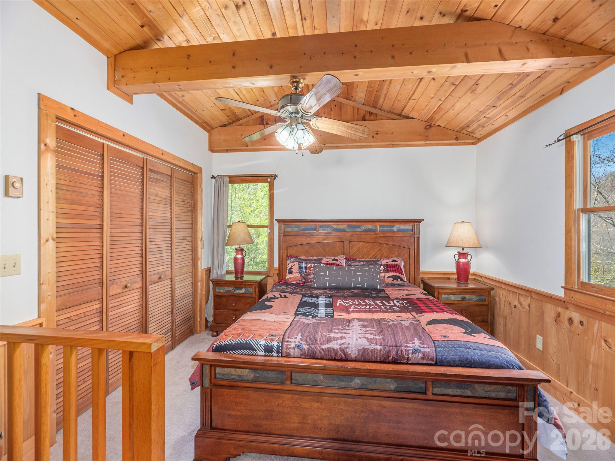 240 Plott Balsam Road Maggie Valley, NC 28751 - Photo 13 of 24 a bedroom with a bed and a chandelier