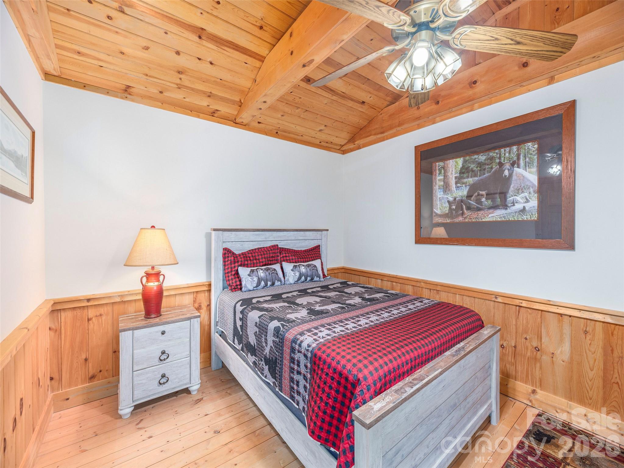 240 Plott Balsam Road Maggie Valley, NC 28751 - Photo 15 of 24 a bedroom with a bed and a chandelier