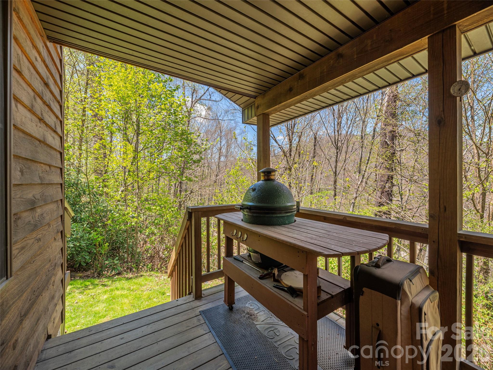 240 Plott Balsam Road Maggie Valley, NC 28751 - Photo 18 of 24 a view of balcony with a table and chairs