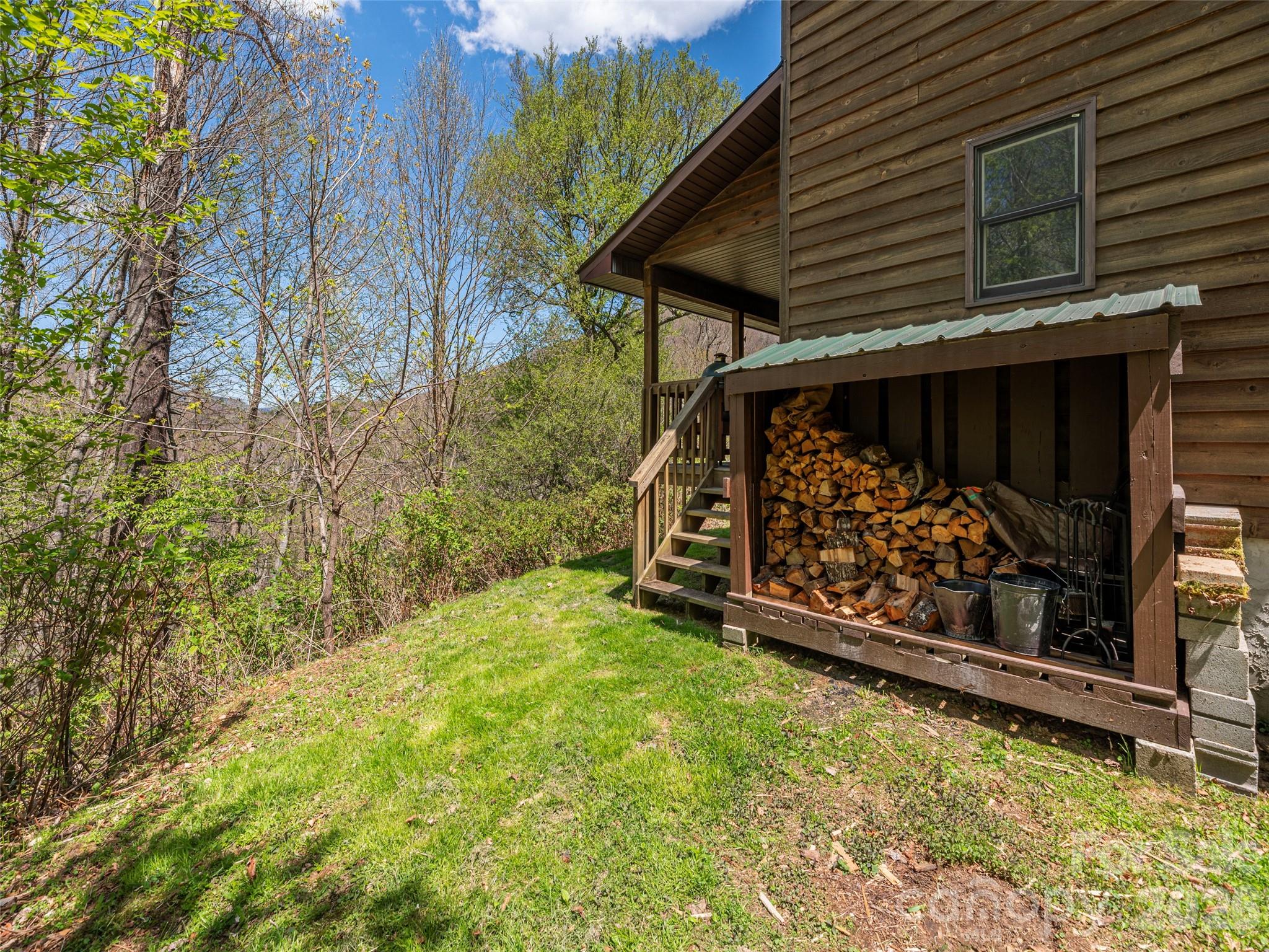 240 Plott Balsam Road Maggie Valley, NC 28751 - Photo 19 of 24 a view of a backyard with wooden fence and a bench