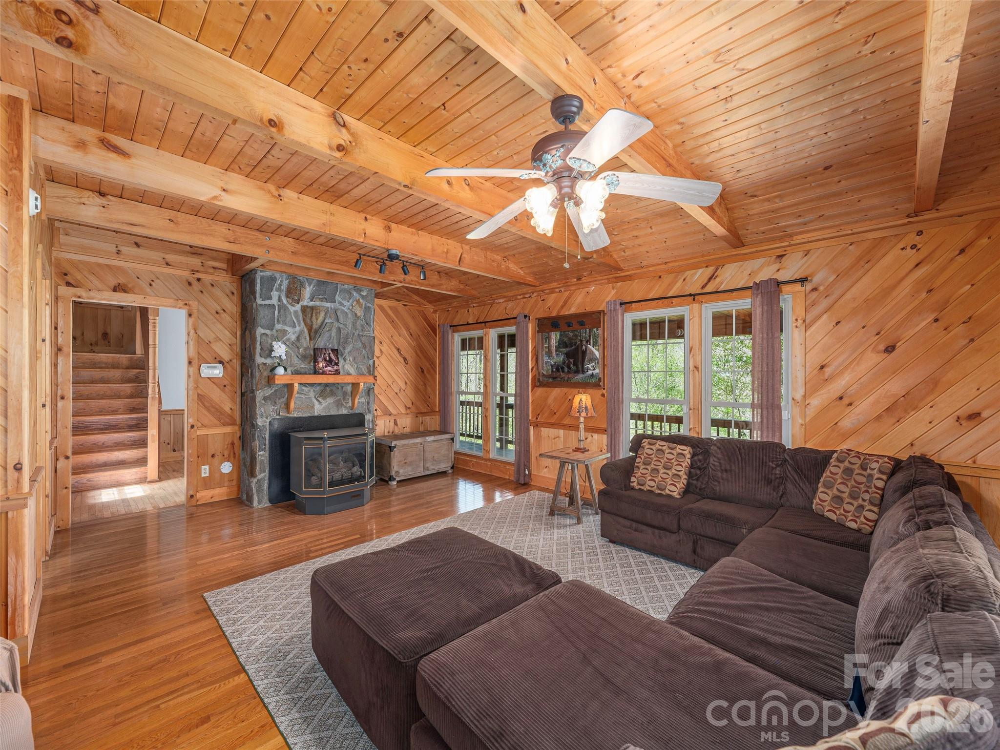 240 Plott Balsam Road Maggie Valley, NC 28751 - Photo 4 of 24 a living room with furniture and a fireplace