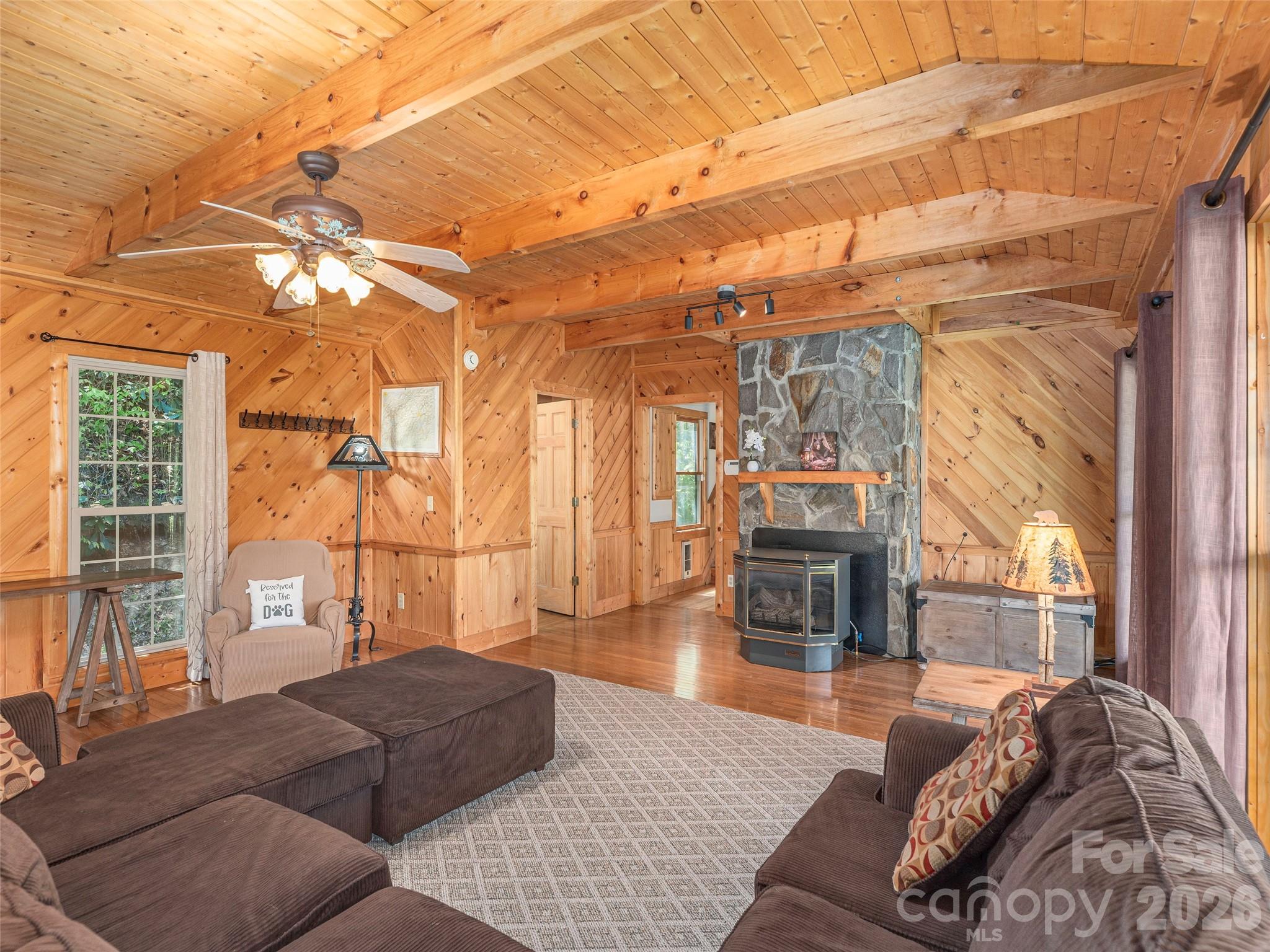 240 Plott Balsam Road Maggie Valley, NC 28751 - Photo 6 of 24 a living room with furniture and a fireplace