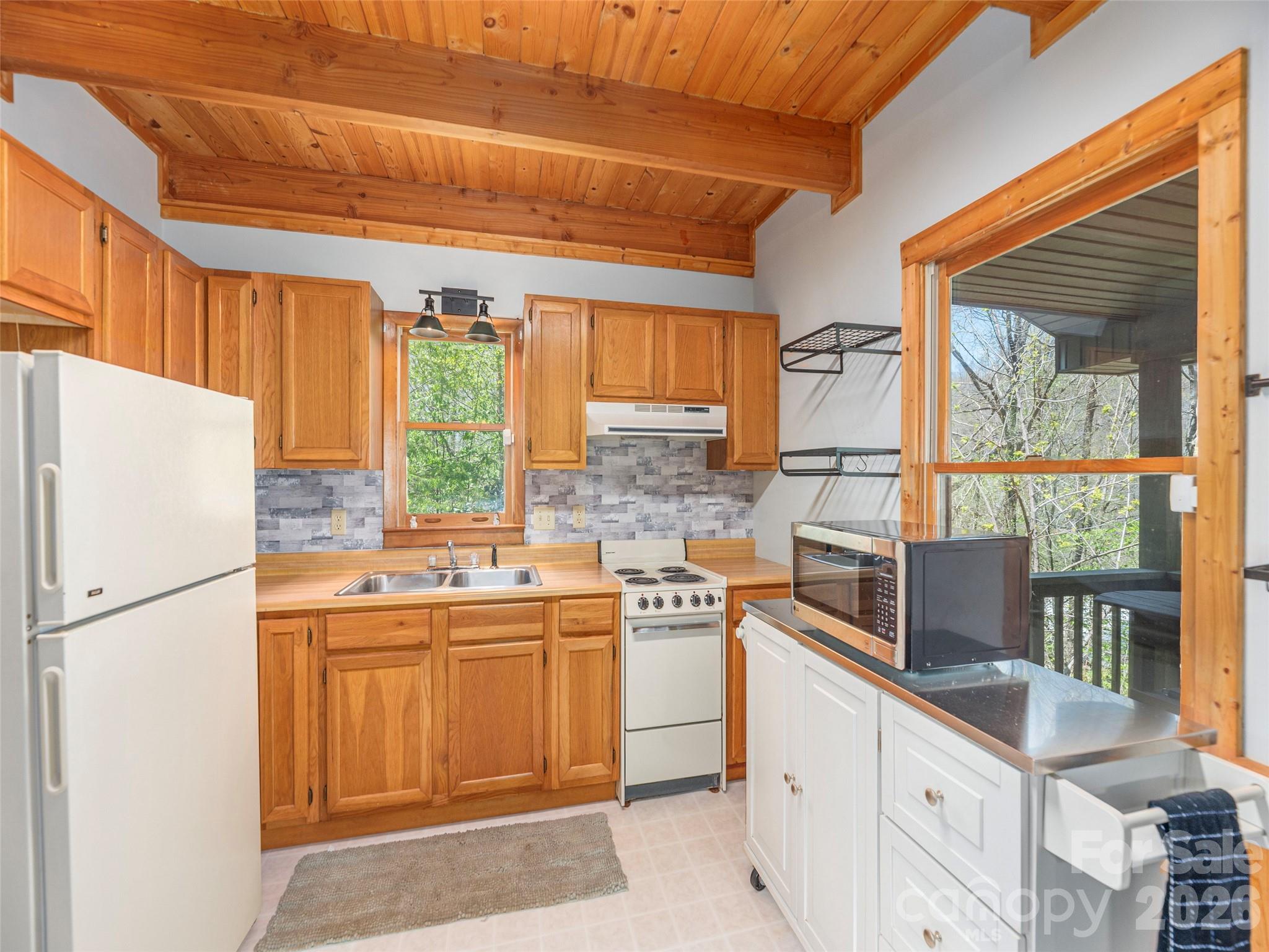 240 Plott Balsam Road Maggie Valley, NC 28751 - Photo 10 of 24 a kitchen with a sink stove and refrigerator