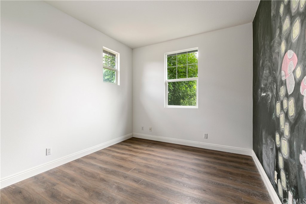 4 Bainbridge Avenue Ladera Ranch, CA 92694 - Photo 16 of 23 an empty room with wooden floor and windows