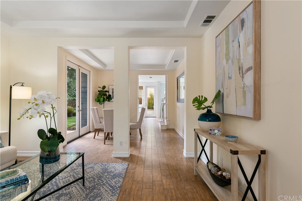 4 Bainbridge Avenue Ladera Ranch, CA 92694 - Photo 4 of 23 a view of a hallway with wooden floor and a potted plant