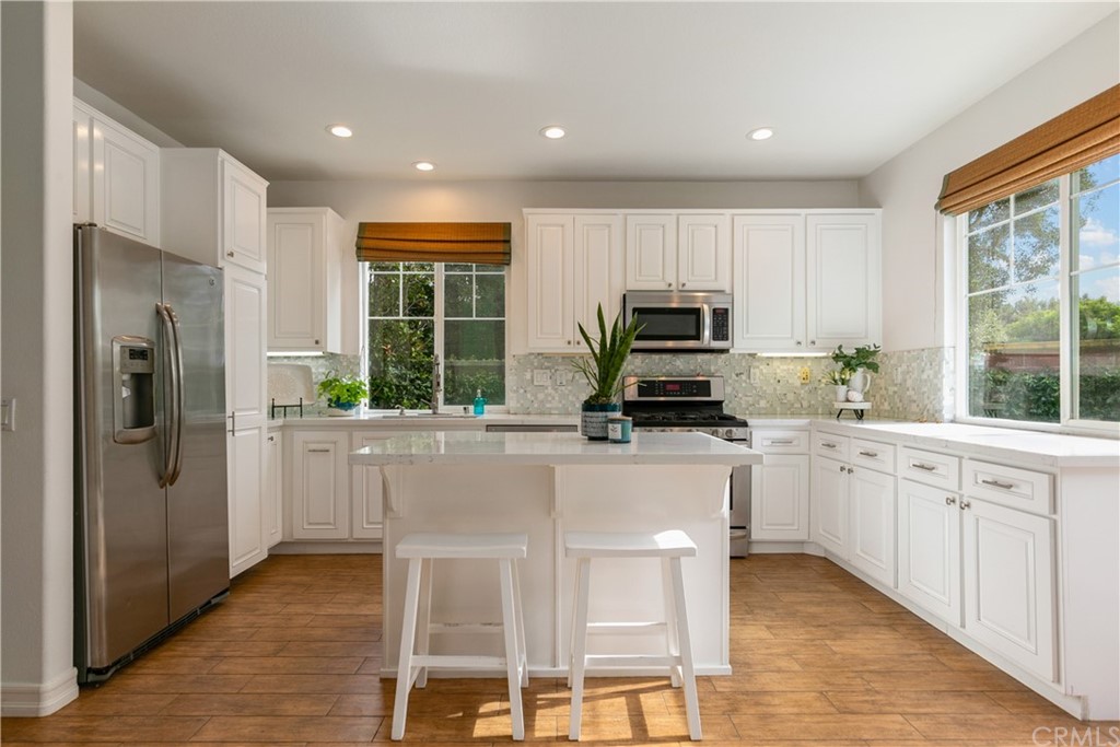 4 Bainbridge Avenue Ladera Ranch, CA 92694 - Photo 6 of 23 a kitchen with kitchen island granite countertop appliances cabinets and a sink