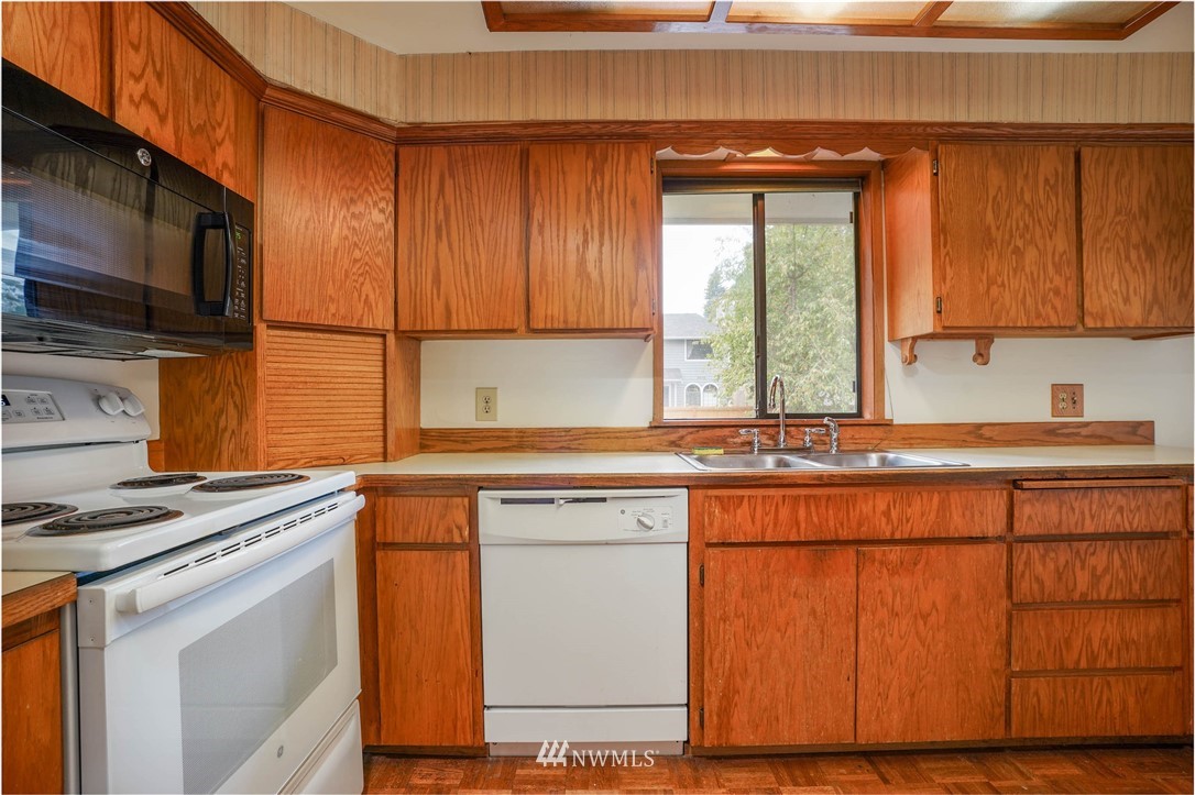 3004 Morrison Road West University Place, WA 98466 - Photo 14 of 39 a kitchen with stainless steel appliances granite countertop a stove a sink and a microwave