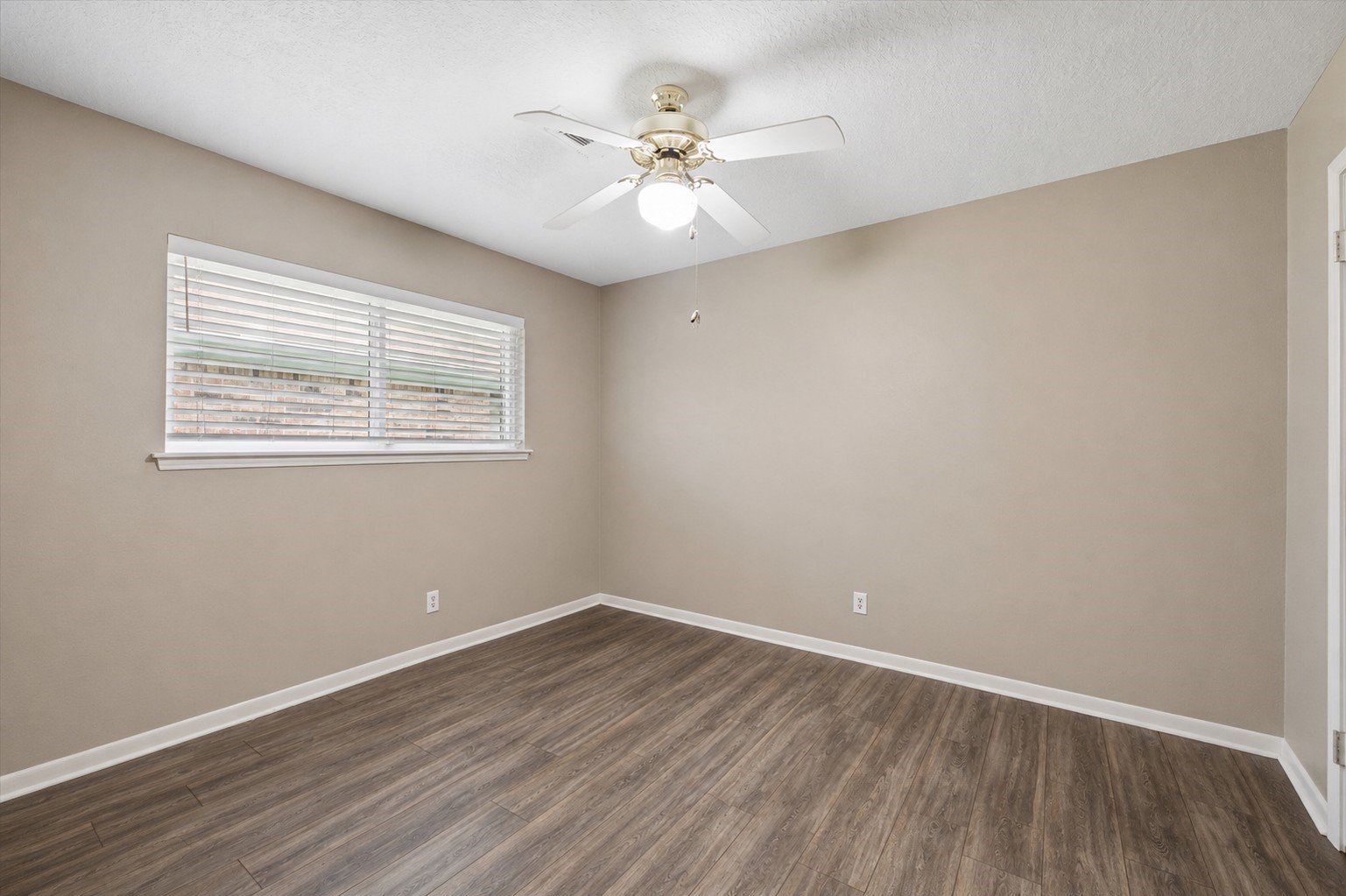 2102 Casa Rio Circle Dickinson, TX 77539 - Photo 15 of 22 The second guest bedroom is equally spacious and features seamless wood-like tile flooring, neutral paint tones, and a large window that fills the room with natural light. This versatile space offers flexibility for a home office, hobby room, fitness studio, craft room, reading retreat, or creative workspace to accommodate your lifestyle!!! ***Bonus ~ Walk in closet***
