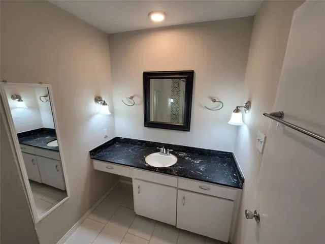 a view of a door space with a bathroom