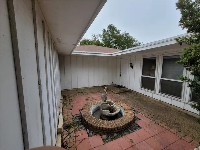 a living room with a couch and a potted plant