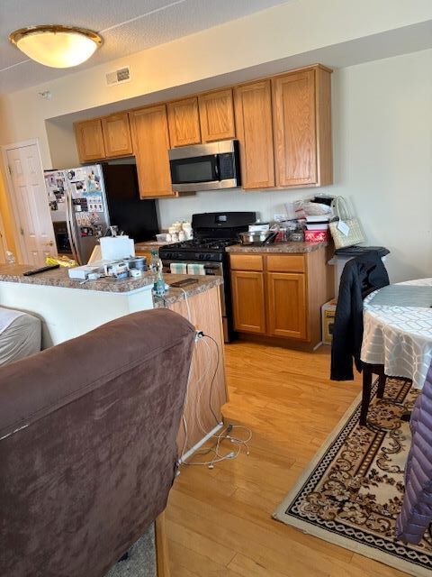 77 North Wolf Road, Unit 210 Northlake, IL 60164 - Photo 5 of 16 a bed room with a bed and a chair