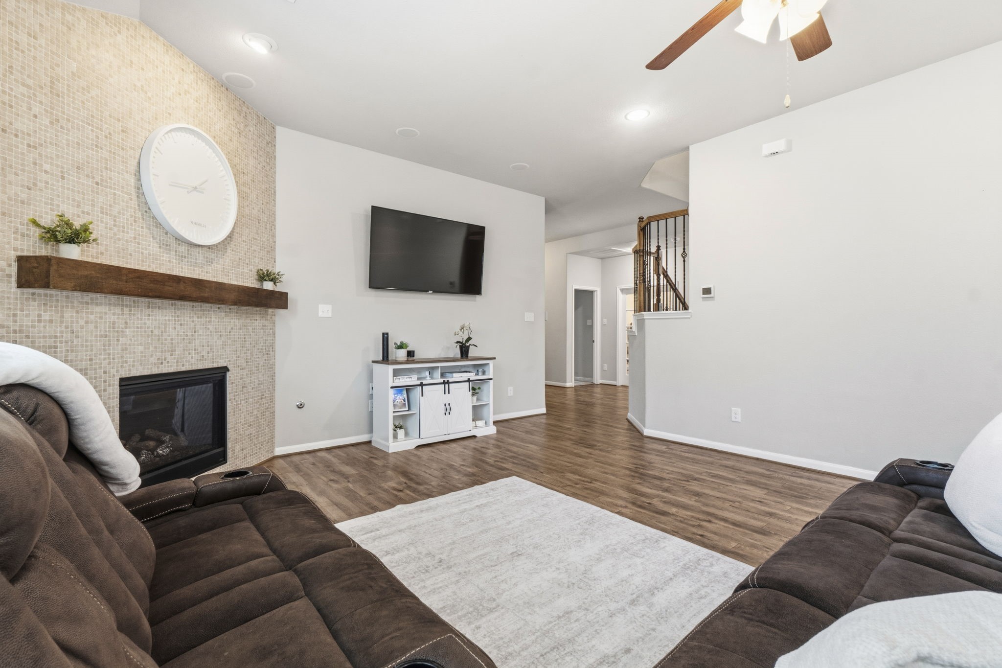 3900 Enchanted Timbers Lane Spring, TX 77386 - Photo 11 of 49 a living room with furniture a flat screen tv and a fireplace