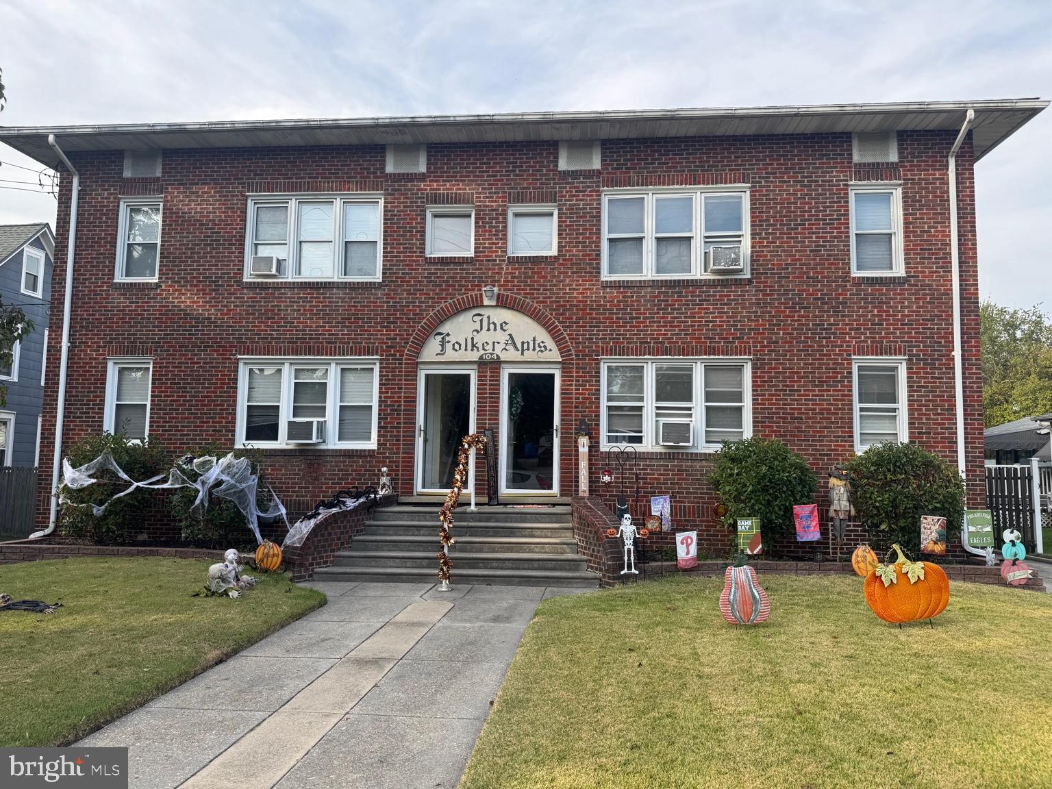 a front view of a house with outdoor seating