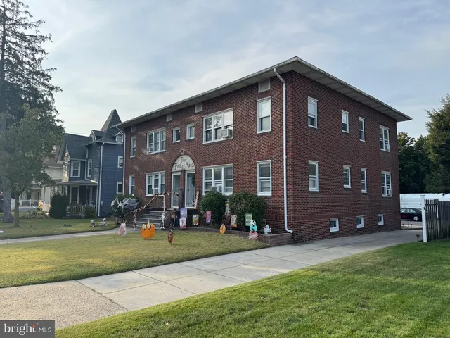 a front view of building with yard