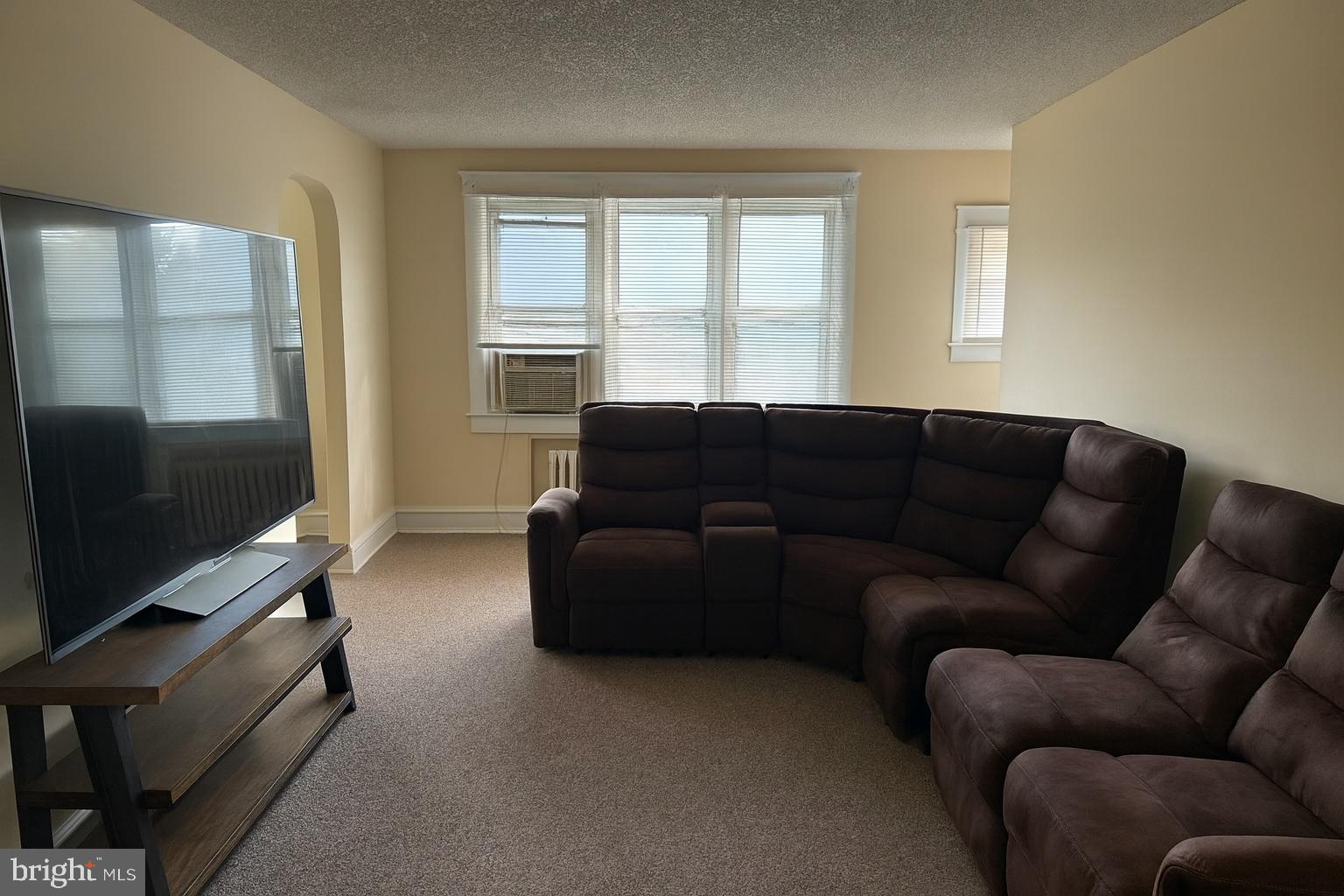 104 Main Street, Unit 4 Bridgeport, NJ 08014 - Photo 3 of 12 a living room with furniture and a flat screen tv
