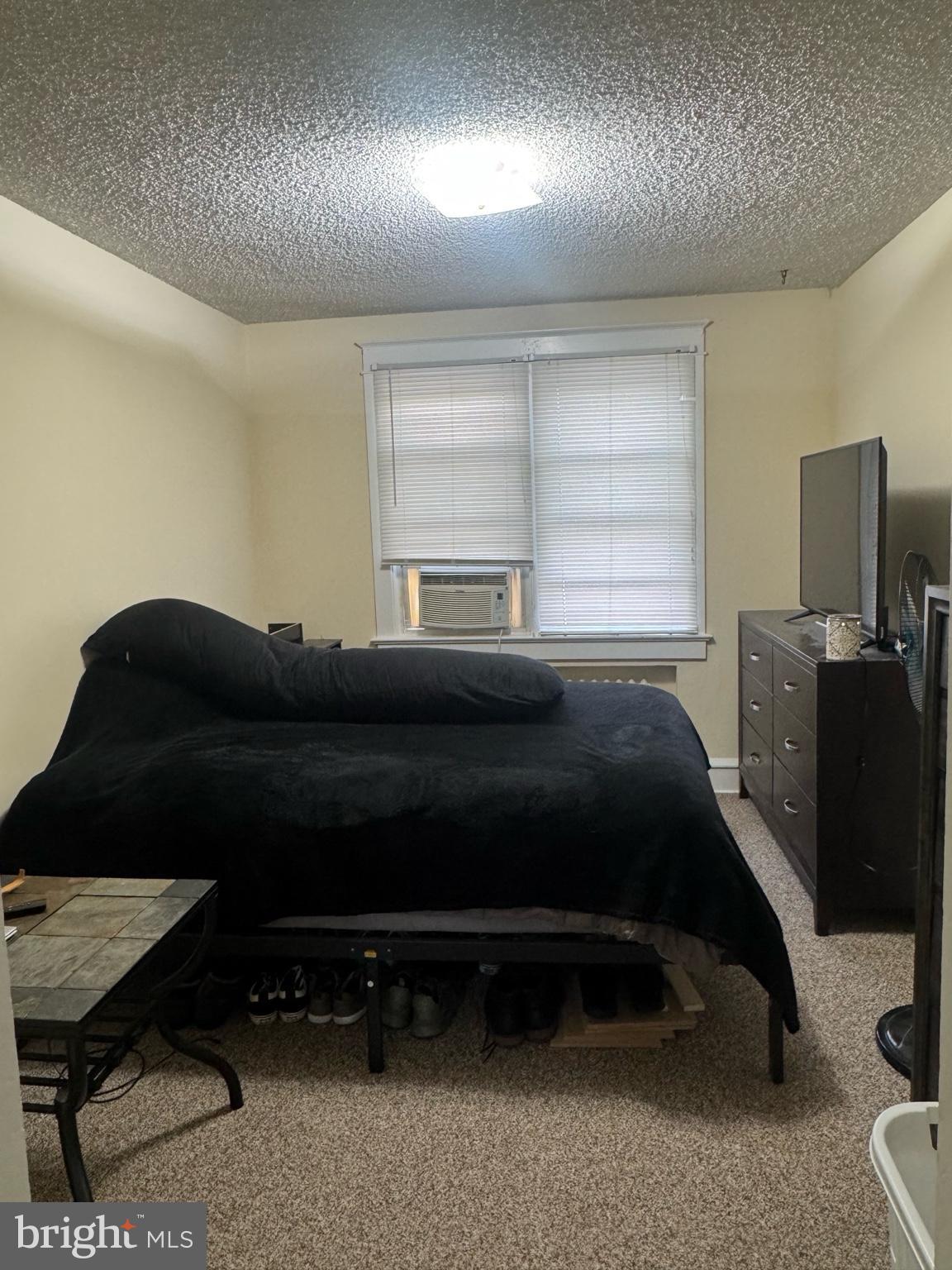 104 Main Street, Unit 4 Bridgeport, NJ 08014 - Photo 7 of 12 a bedroom with a bed and wooden floor