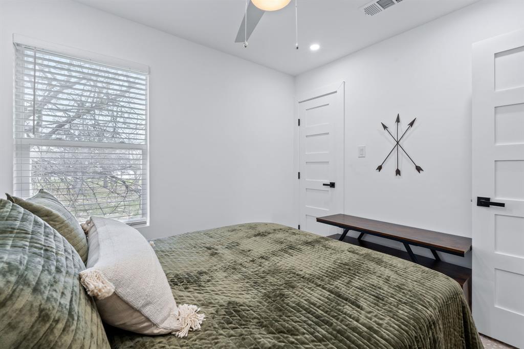 2706 Wheless Lane, Unit 401 Austin, TX 78723 - Photo 18 of 24 A well-lit bedroom with modern doors and a tranquil view from the window.