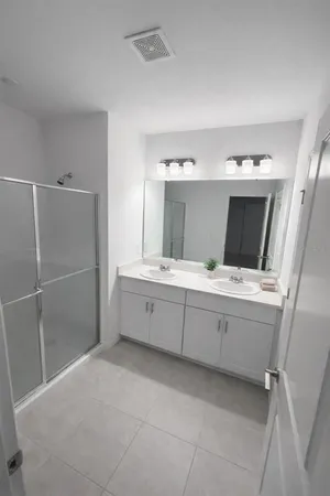 a bathroom with a tub sink and mirror