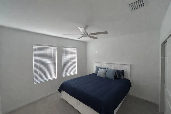 a bedroom with a bed and window