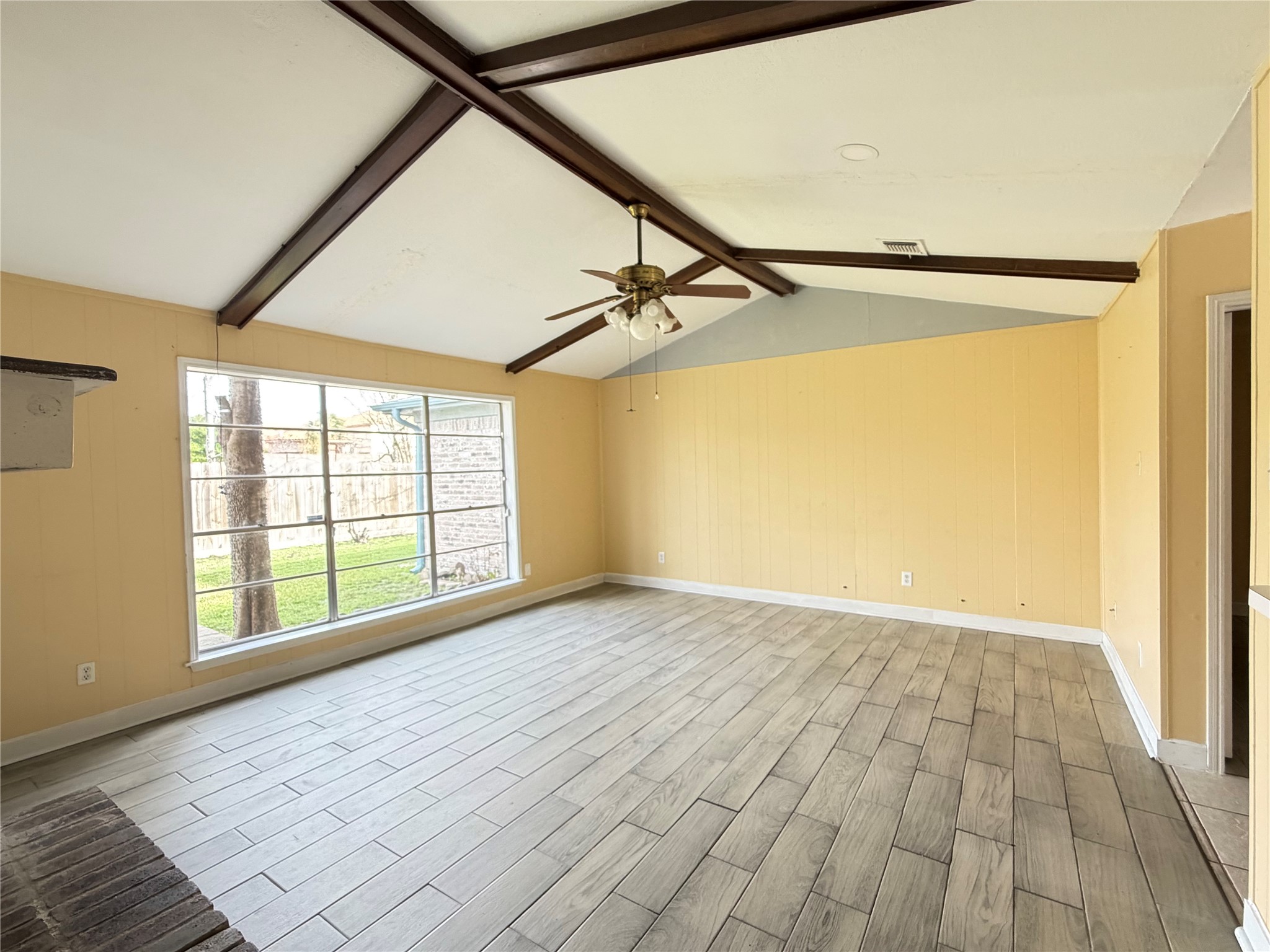 13722 Burgoyne Road Houston, TX 77077 - Photo 5 of 10 a view of an empty room with a window and wooden floor