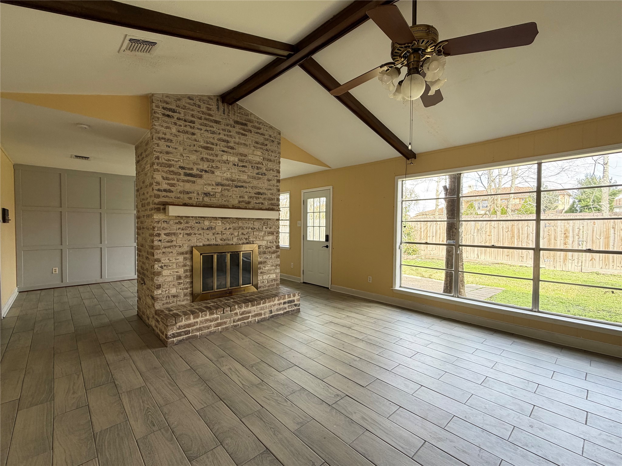 13722 Burgoyne Road Houston, TX 77077 - Photo 10 of 10 a view of an empty room with a fireplace and a window