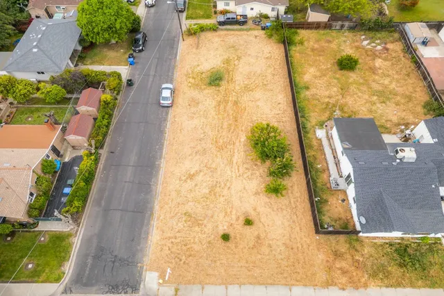 an aerial view of residential houses with outdoor space